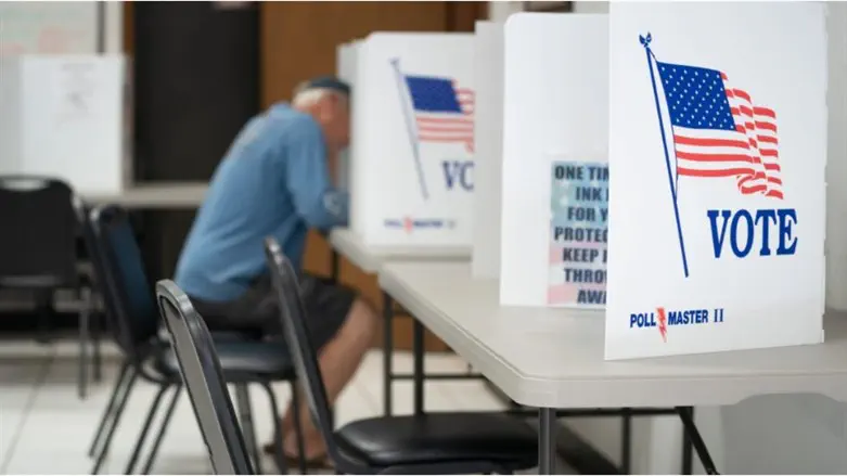 A man fills out a ballot at a voting booth in Mt. Gilead, North Carolina