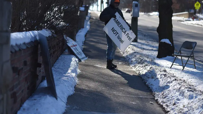A protester stands outside Beth Israel Congregation in Ann Arbor, Michigan, in 2020.