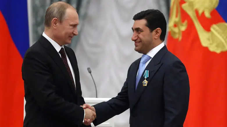 Russian Pres. Putin (L) shakes hands with God Nisanov in the Kremlin