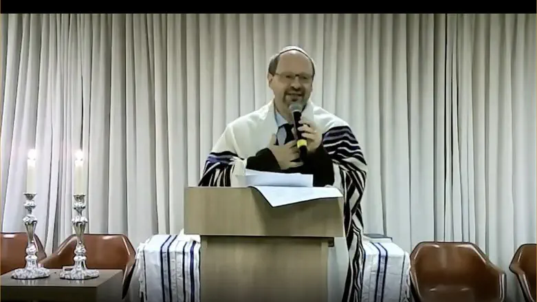 Uri Lam leads a mourning ceremony including the names of the two men killed