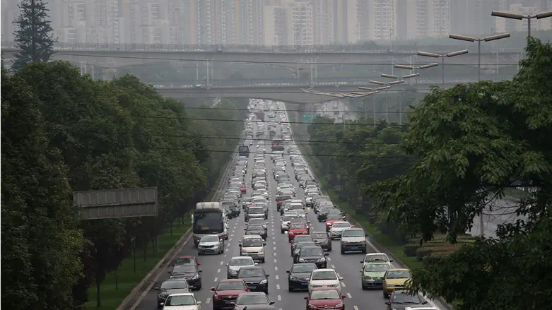 Commuter traffic flows from a skyline of apartment buildings in Chengdu, China,