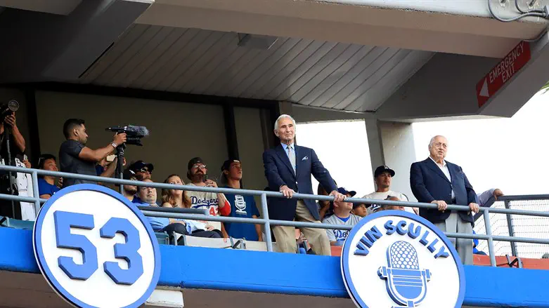 Sandy Koufax and Tommy Lasorda stand next to the Vin Scully plaque
