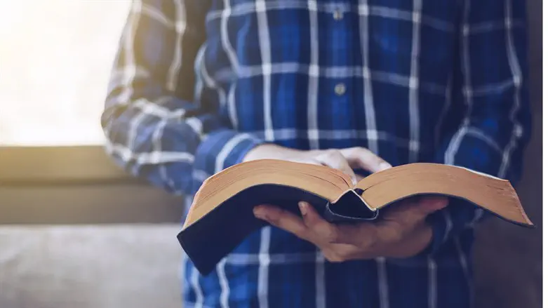 Man reading New Testament (stock)