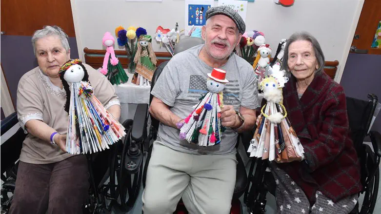 Residents at Menorah Center for Rehabilitation & Nursing Care with hand-crafted dolls