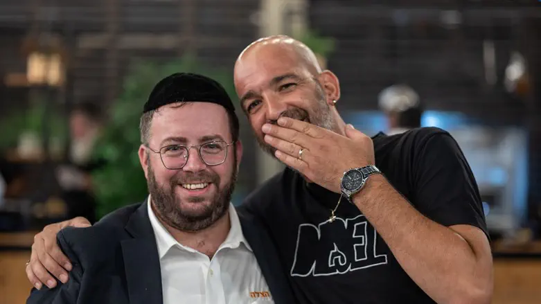 Moshe Ben Yishai standing with Naftali Rotenberg who rescued him
