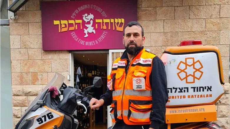 Chezi Roth with his ambucycle in front of his store
