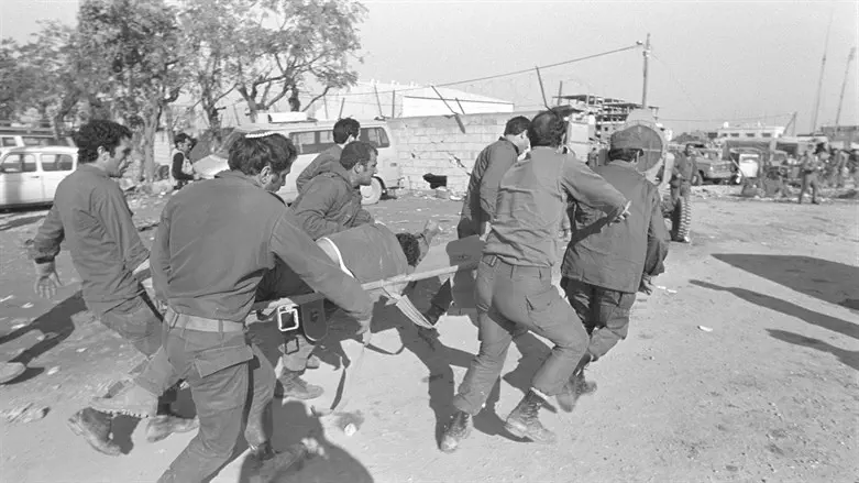IDF soldiers evacuate injured out of collapsed HQ in Tyre, Lebanon, 1982
