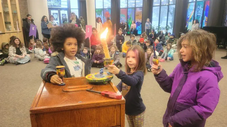 Children light candles as part of their lessons at Yachad Religious School in Oa