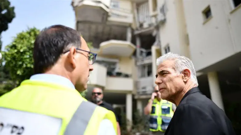 Яир Лапид на месте попадания ракеты в Реховоте