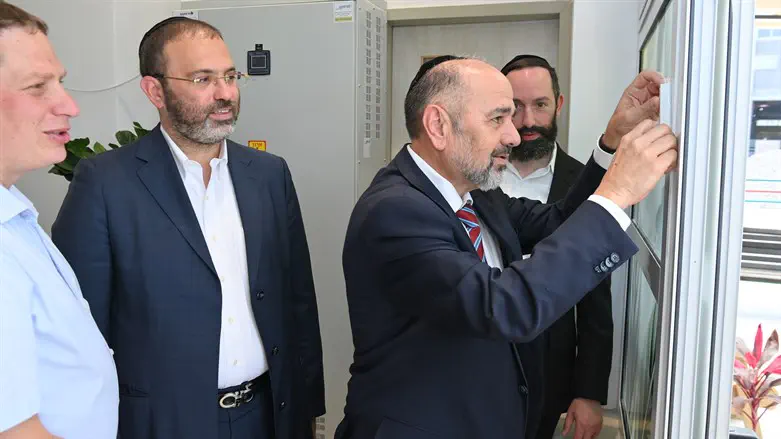 Yaakov Margi affixes mezuzah at Perach communal village