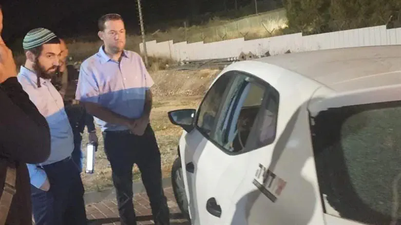 MK Sukkot with head of Shomron Regional Council at the scene of the attack