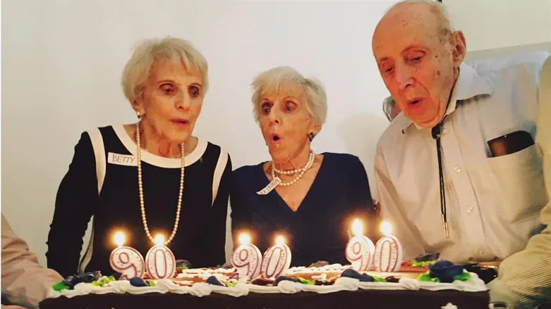 Betty Woolf, left, and her siblings Minna and Joseph celebrate their 90th birthday in 2017