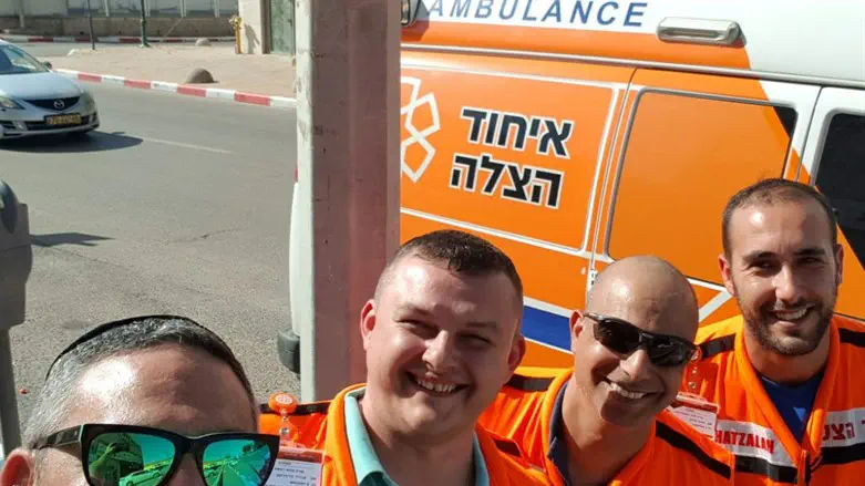 Shlomi Asraf (right) together with other United Hatzalah volunteers on an ambula