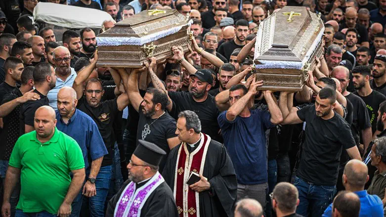 Mourners carry the coffins of two of the five men who were murdered in Nazareth