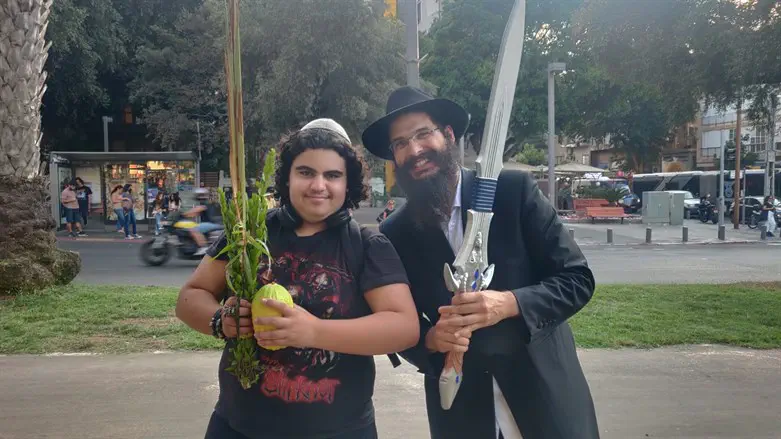 Chabad shaliach shakes lulav with TA resident