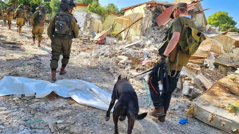 IDU volunteer searches a town targeted by Hamas