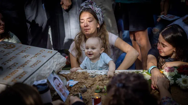 Little Shaked smiles for photograph at his father's grave
