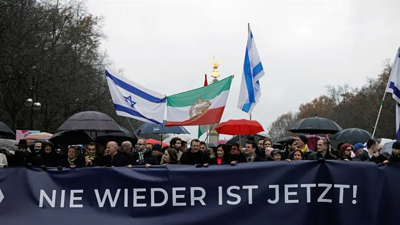 A banner reads "Never again is now!" at a pro-Israel rally in Berlin, Dec. 10, 2023.