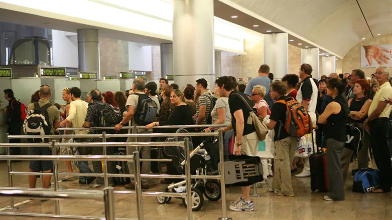 People wait in line at passport control at Ben Gurion International Airport in Tel Aviv
