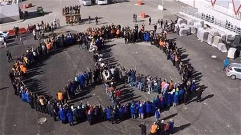 'SodaStream' factory workers form peace sign