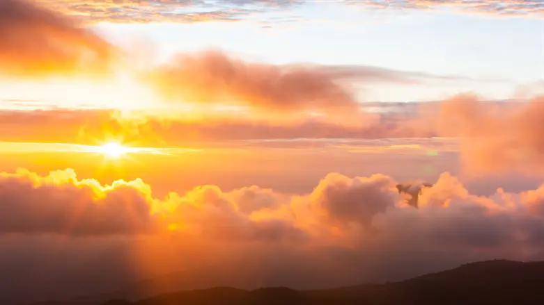 Sun peeking out from behind clouds