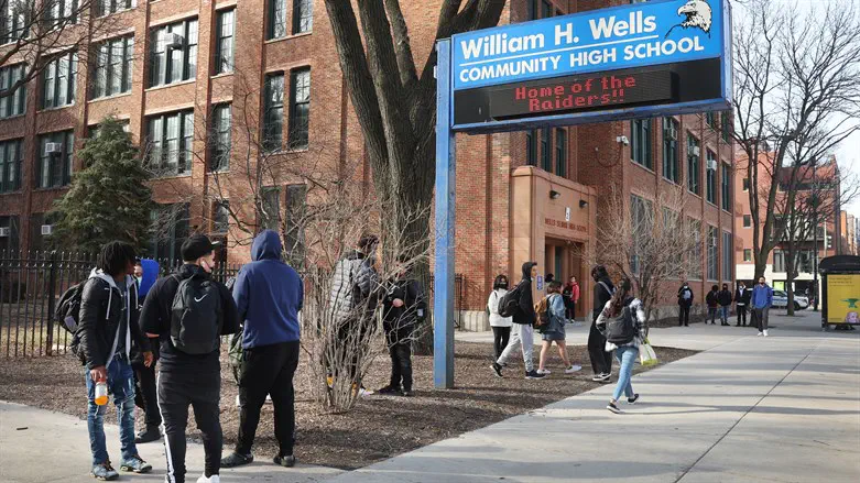 Students leave William Wells High School, part of Chicago Public Schools, March 2022.