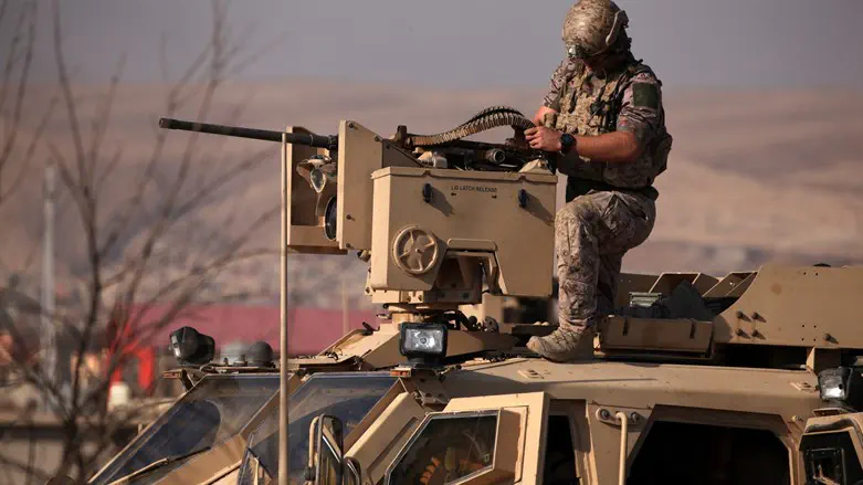 American soldier on armored vehicle in Iraq