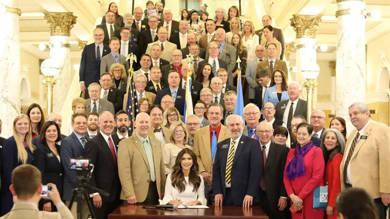 Signing the bill at the State Capitol