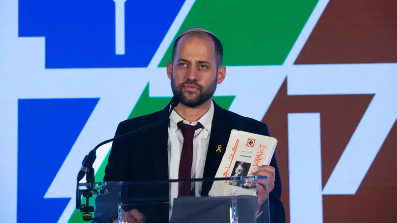 Davidi Ben Zion shows the book that was found in Gaza