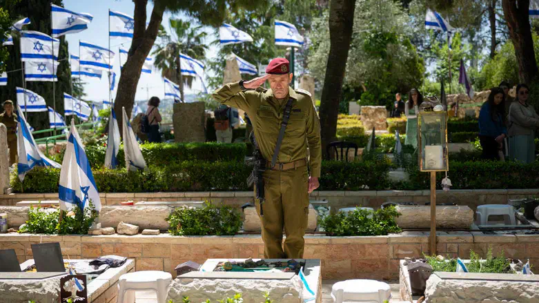 Herzi Halevi at the graves of fallen soldiers