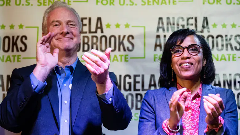 Angela Alsobrooks claps with Maryland Sen. Chris Van Hollen