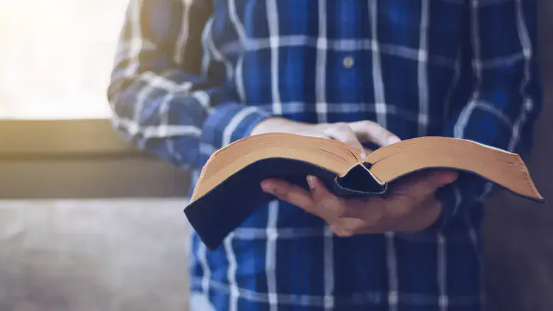Man reading Bible and New Testament