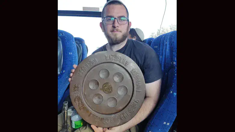 Or, a solider fighting in Gaza, displays a seder plate he found in the territory.