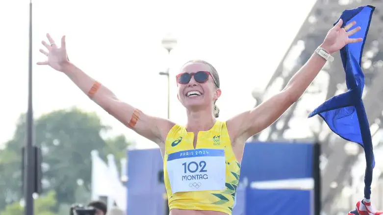 Jemima Montag celebrates after crossing the finish line during the mixed marathon racewalk