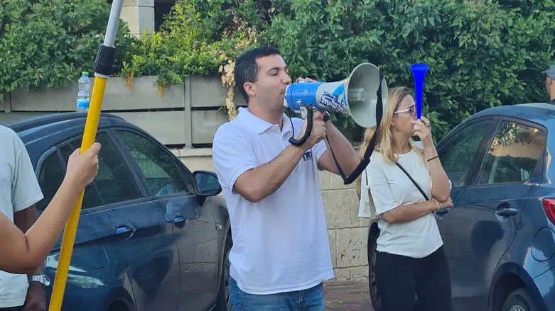 Im Tirtzu activists protest outside Arnon Bar David's home