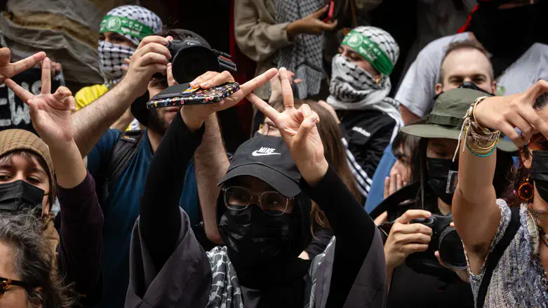 Protesters flash an inverted triangle, a Hamas symbol, at Baruch College in New York City