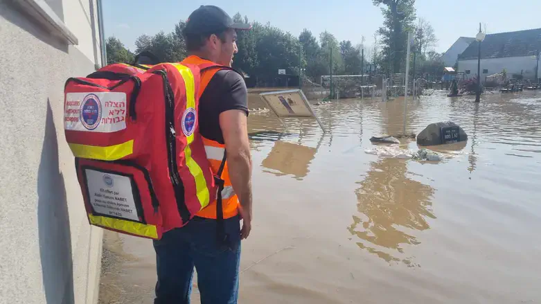 An Israeli volunteer with Rescuers without Borders gazes over floodwaters in Poland