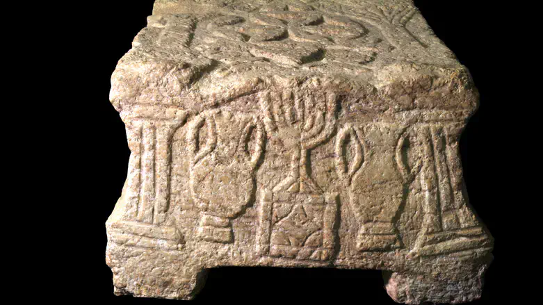 Ancient stone with menorah symbol