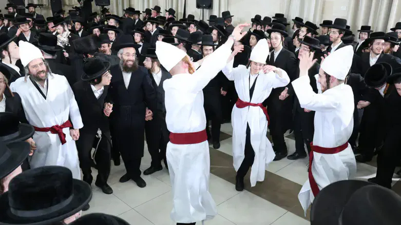The priests in traditional garb dancing