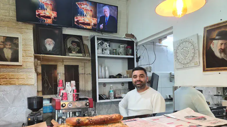 Yitzchak Babayoff, the owner of Pizza Trump in Jerusalem, poses on Inauguration Day 2025.