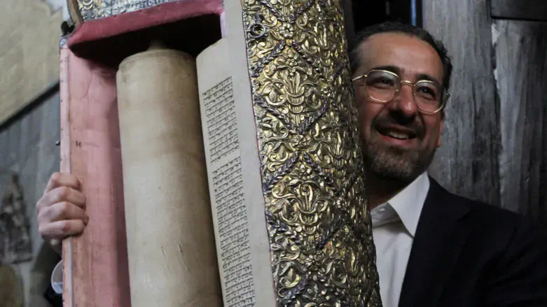 Rabbi Hamra with Torah scroll in Syrian synagogue