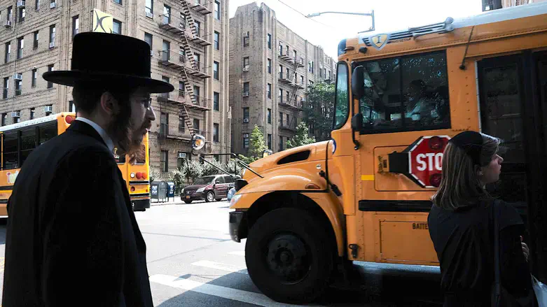 A yeshiva school bus drives through Brooklyn on Sept. 12, 2022.