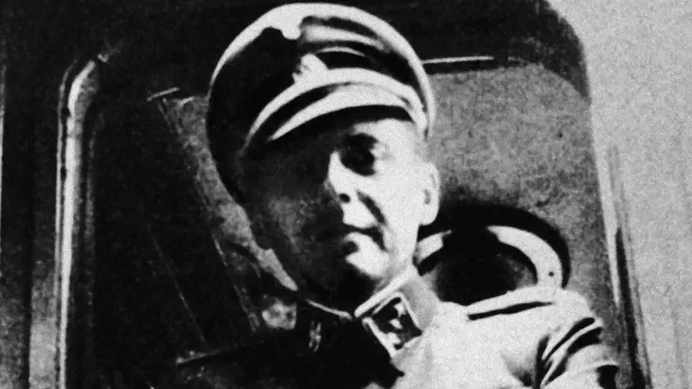 German Nazi doctor Josef Mengele standing at a train window in his SS uniform.