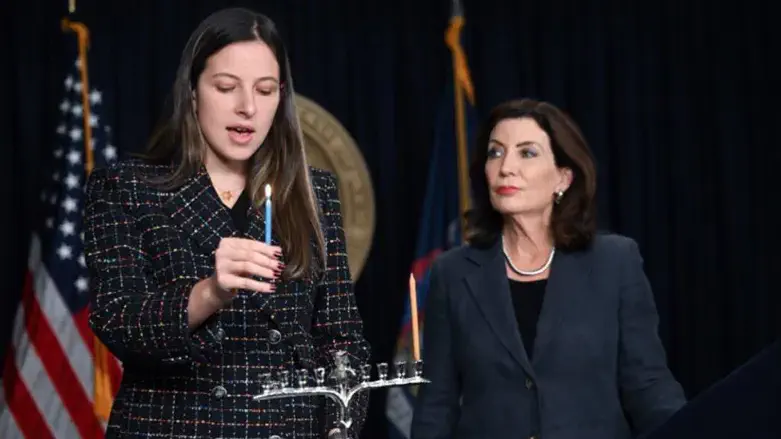 Eva Wyner lights candle with Gov. Hochul