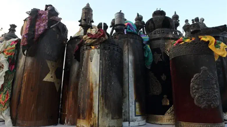 Torah scrolls after shul arson (illustration)