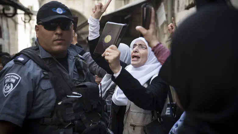 Muslim women shout holding Koran