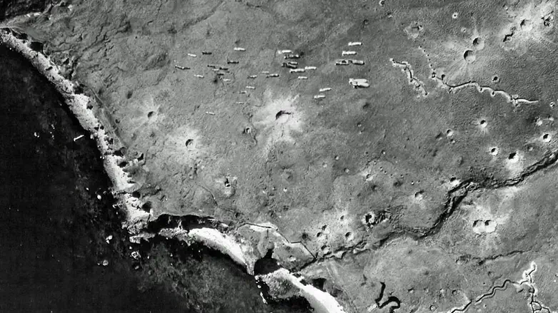 Dozens of bombs fall from a US bomber toward Japanese-occupied Kiska Island, August  1943.
