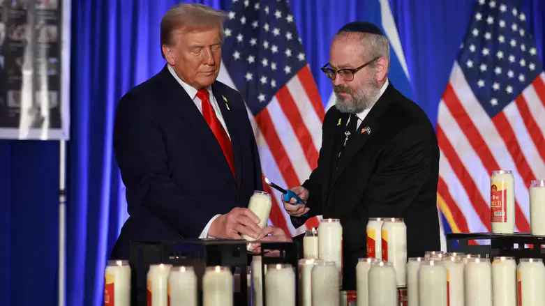 Donald Trump & Yehuda Kaploun light a candle during an Oct. 7 remembrance event in Florida