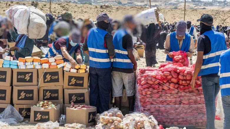 Gazans receive aid at a GHF distribution site