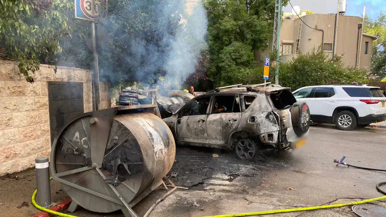 The burned car and garbage bin